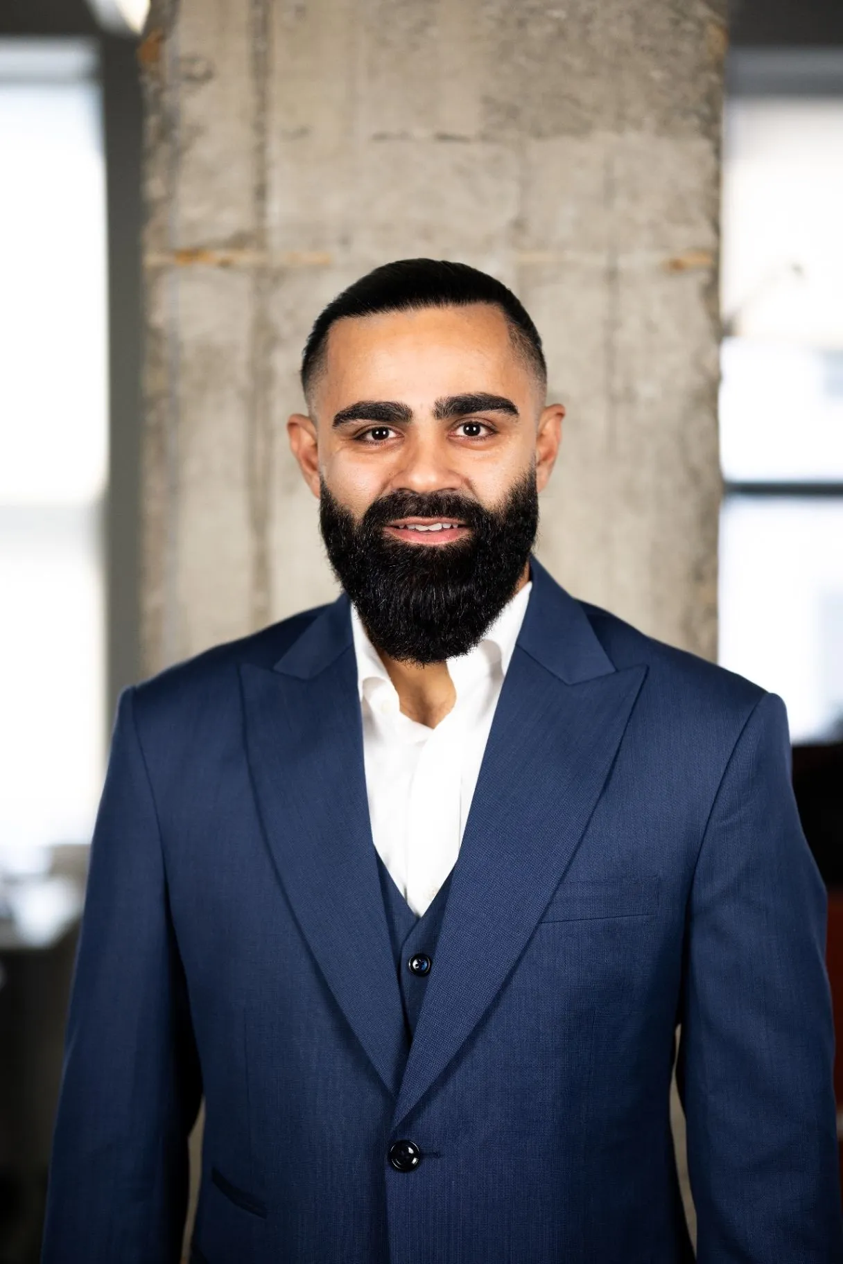 Mike Bhalla in a tailored navy suit